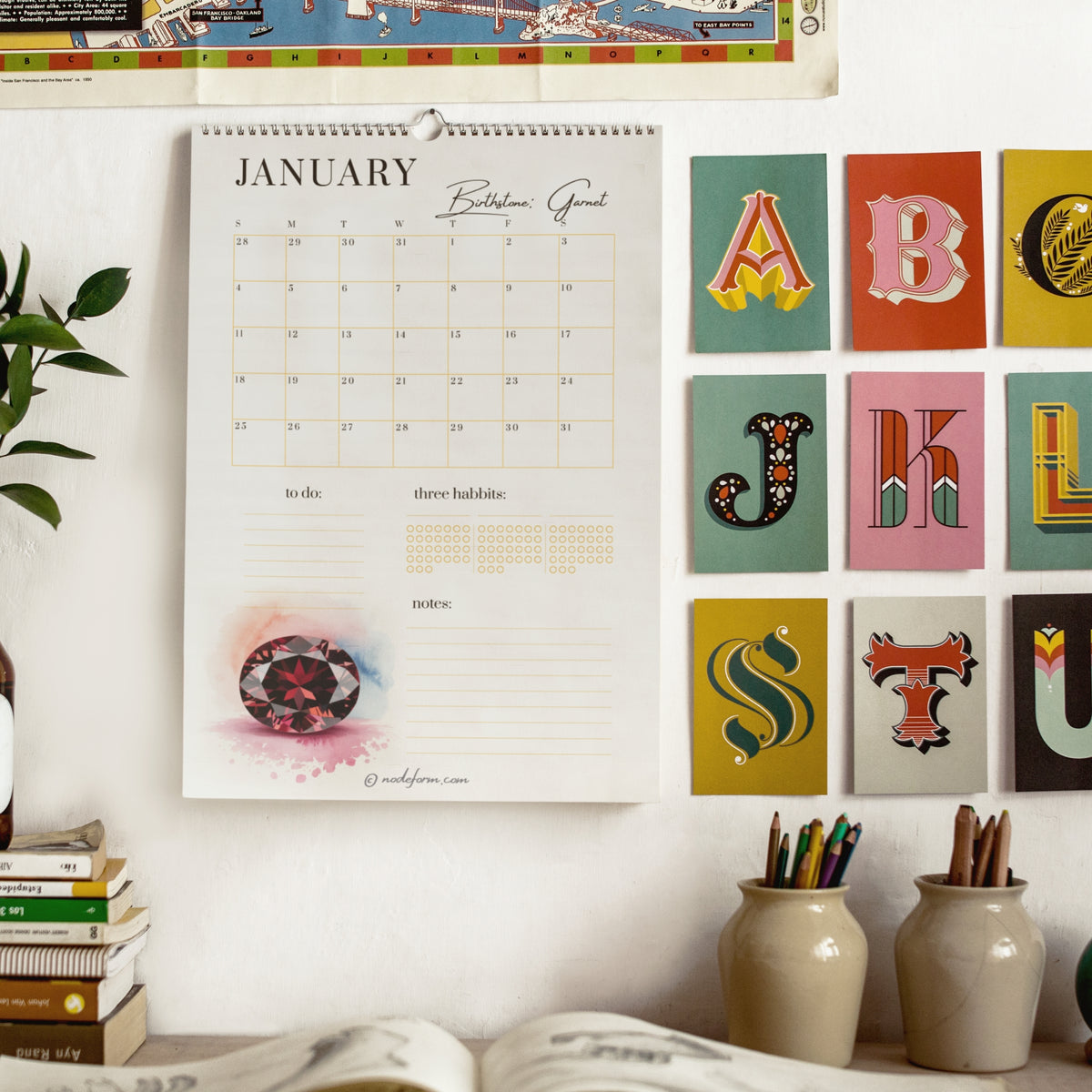 2026 Calendar on a wall with colorful letter tiles and books below