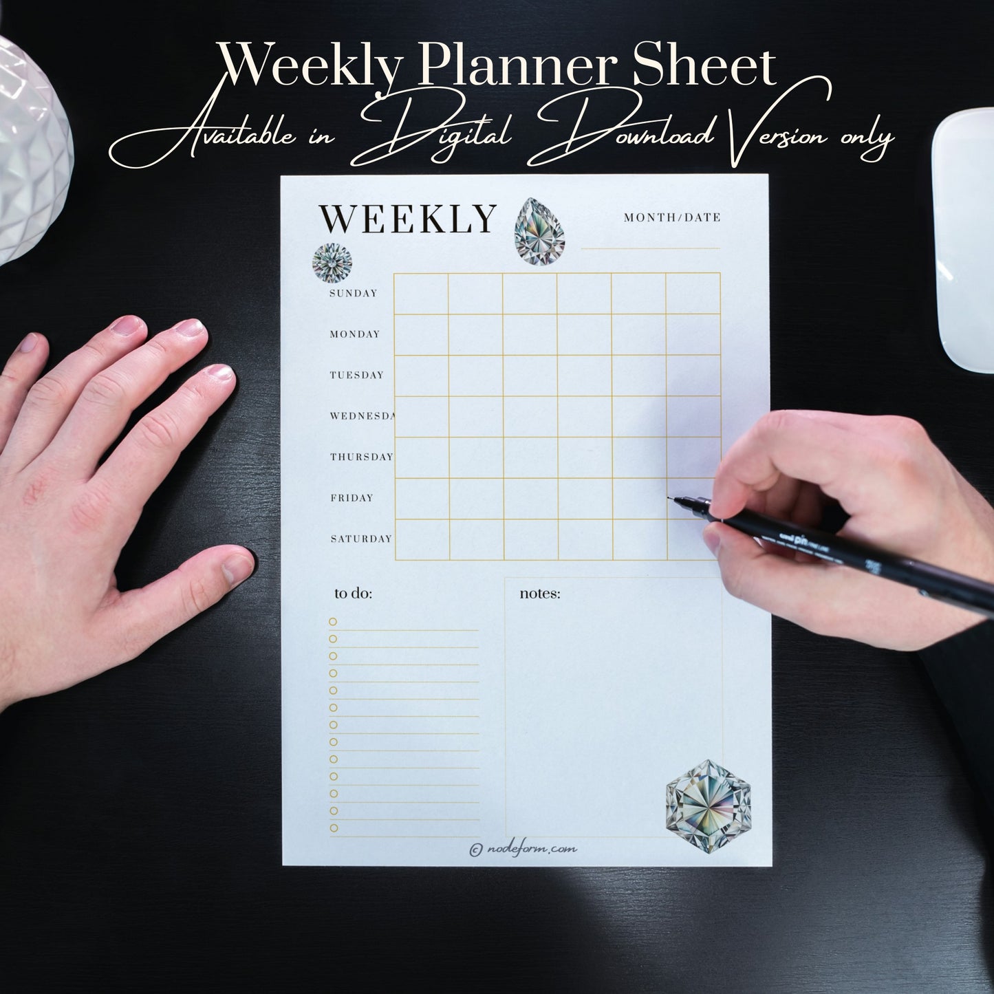 Weekly planner sheet with diamonds elements on a black surface, held by hands with a pen writing down their notes.