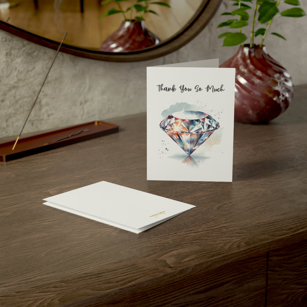 Greeting card with diamond illustration and 'Thank You So Much' text on a wooden surface.