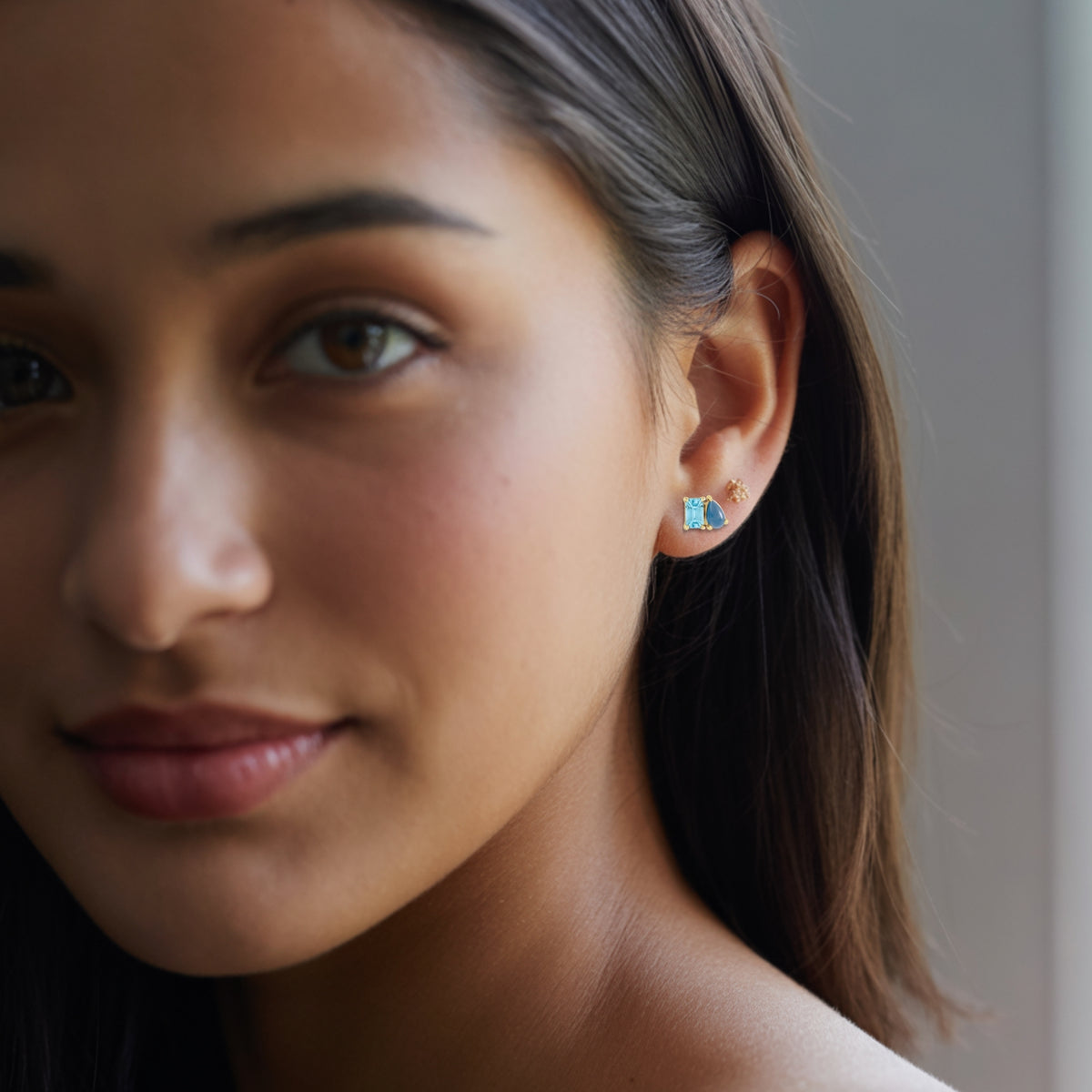 Sky Blue Topaz & Natural London Blue Topaz Two-Stone Stud Earrings on womans ear