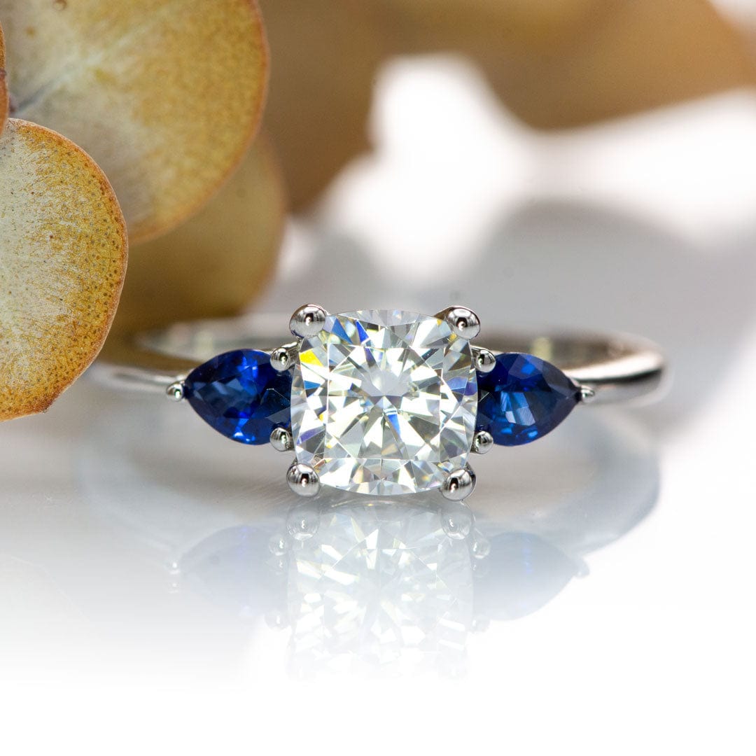Tressa- Three Stone Engagement Ring, Prong set Cushion Moissanite & Pear Blue Sapphire Accents Ring by Nodeform