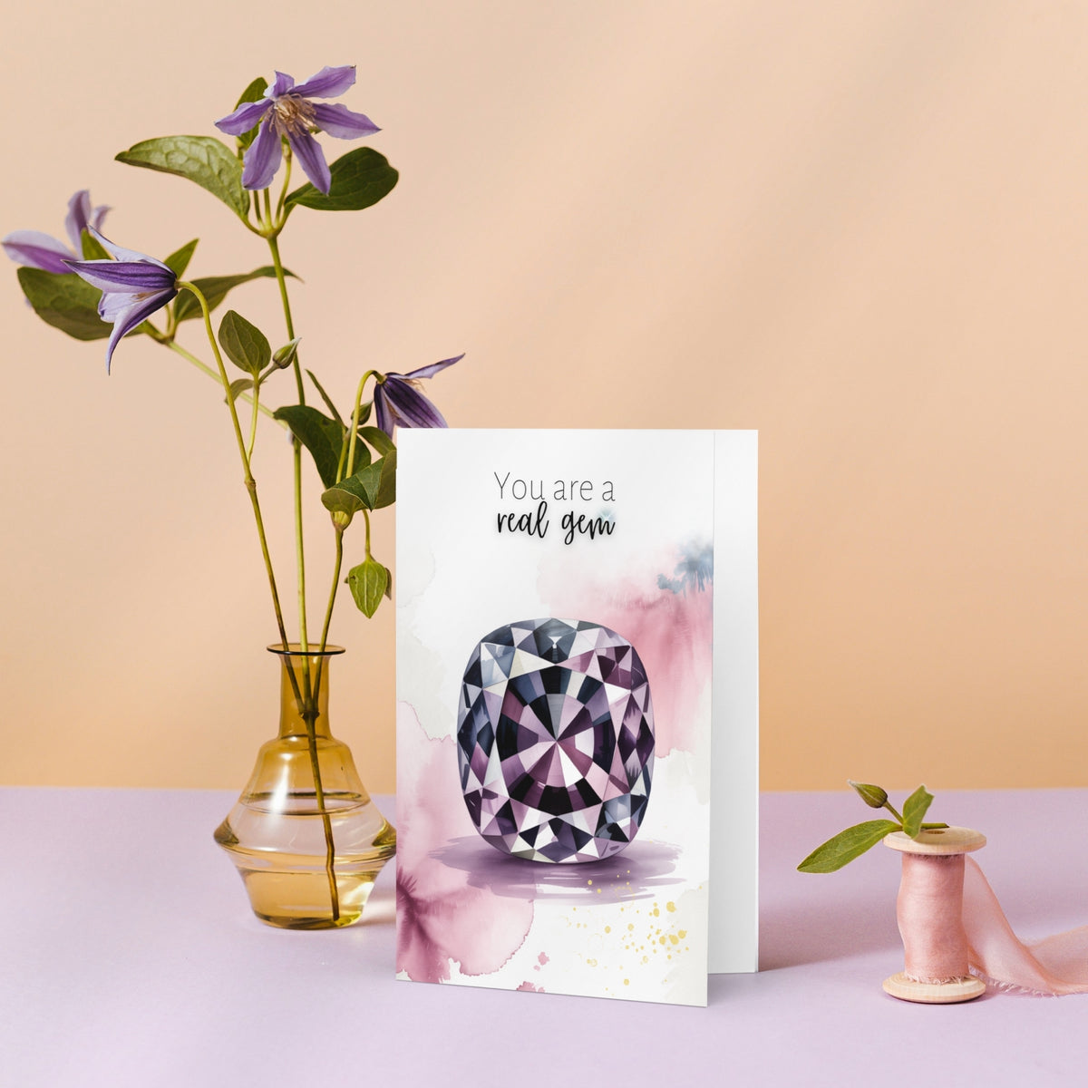 Folded Greeting card with a cushion spinel illustration and flowers on a pink background