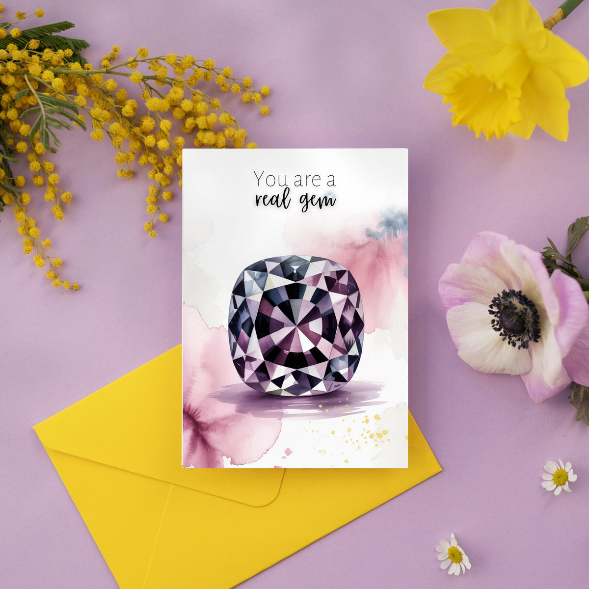 Greeting card with a watercolor spinel illustration and 'You are a real gem' text, surrounded by flowers and an envelope