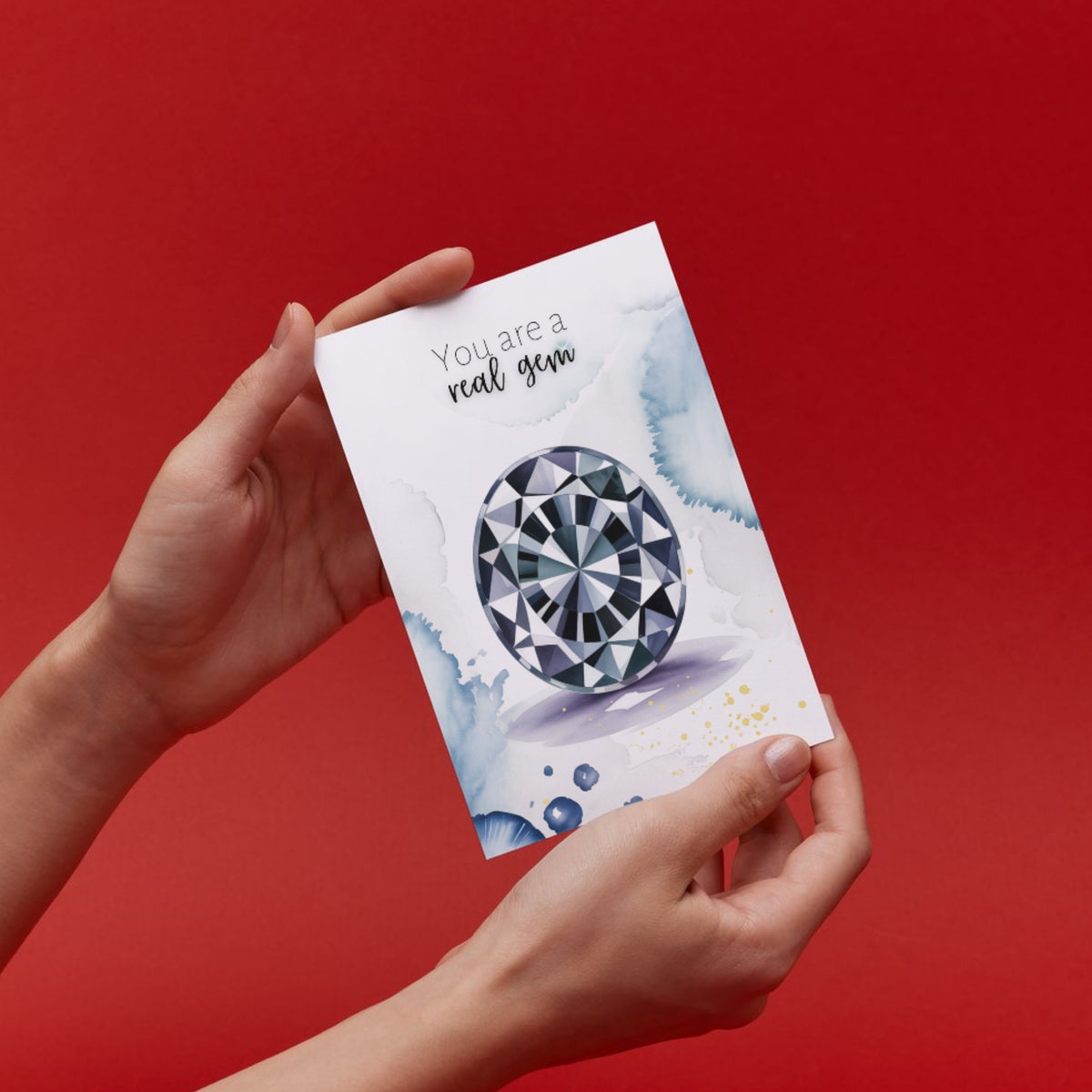 Hand holding a card with a oval Spinel Gemstone illustration and text on a red background