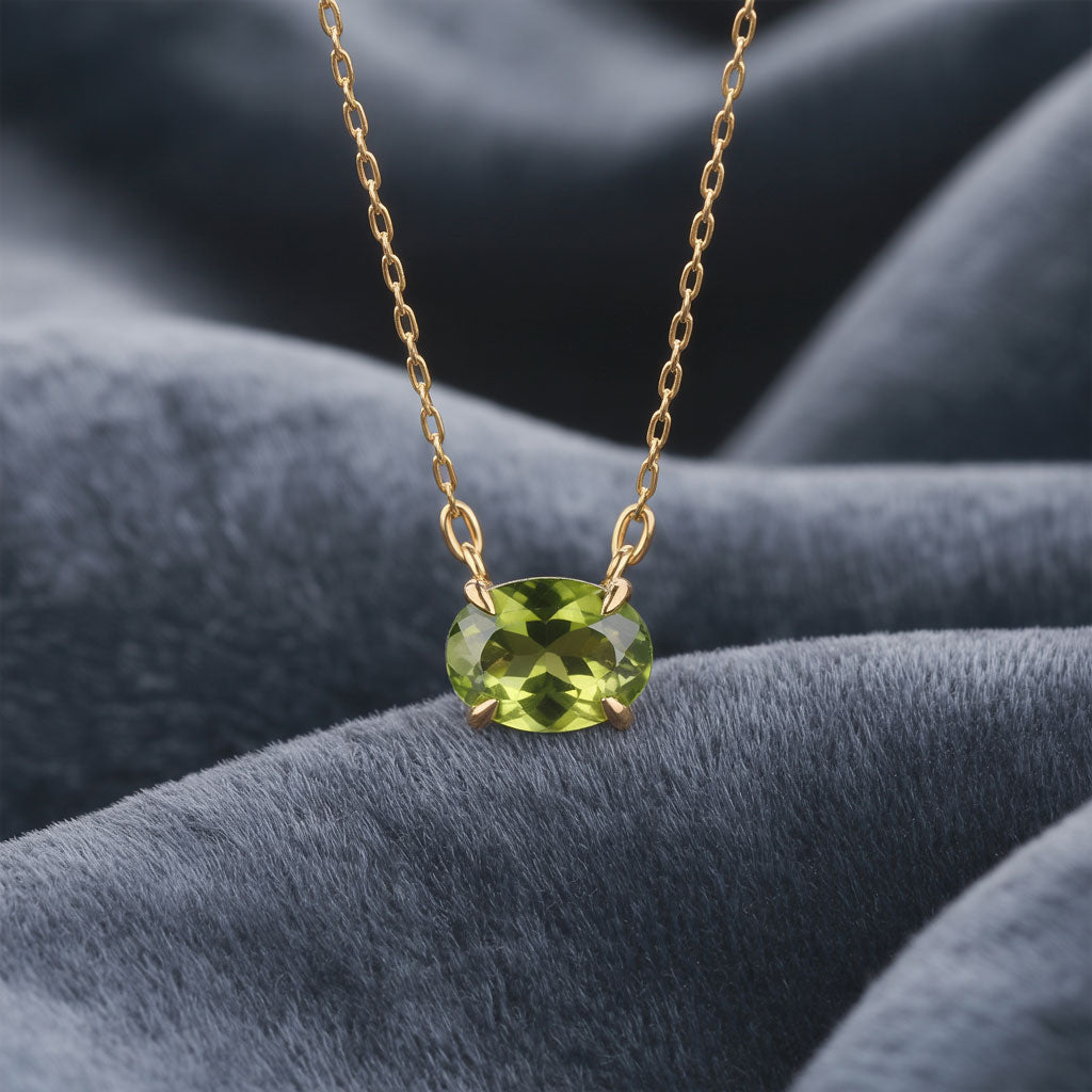 sideways Oval Peridot Prong Set Birthstone Gold Pendant Necklace hanging over gray elvet