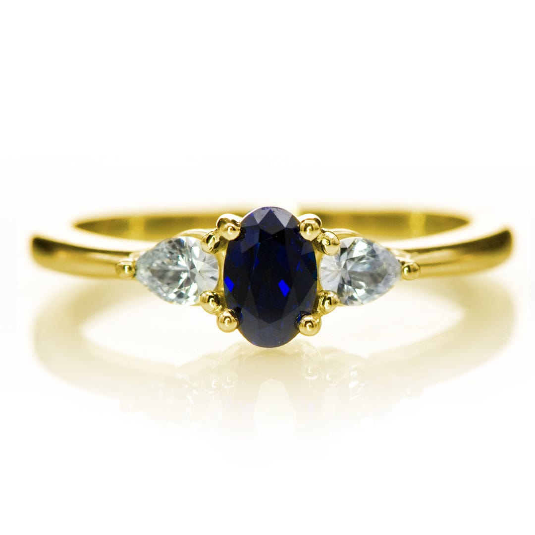 Tressa - Three Stone Prong Set Oval Lab Sapphire Engagement Ring with Pear-shaped White Sapphire Accents 14K Yellow Gold / 6x4 mm/ 0.55ct Lab-Created Blue Sapphire Ring by Nodeform