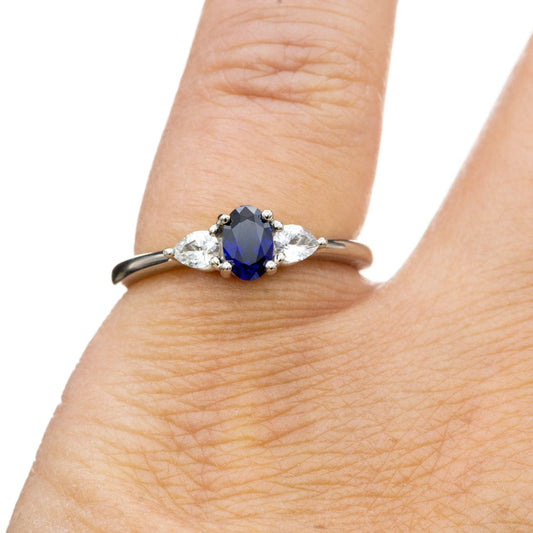 Tressa - Three Stone Prong Set Oval Lab Sapphire Engagement Ring with Pear-shaped White Sapphire Accents Ring by Nodeform