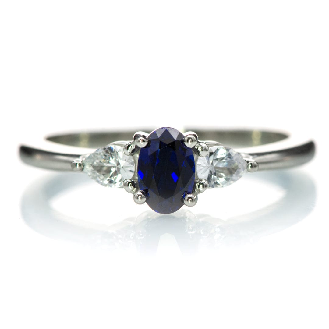 Tressa - Three Stone Prong Set Oval Lab Sapphire Engagement Ring with Pear-shaped White Sapphire Accents Platinum / 6x4 mm/ 0.55ct Lab-Created Blue Sapphire Ring by Nodeform