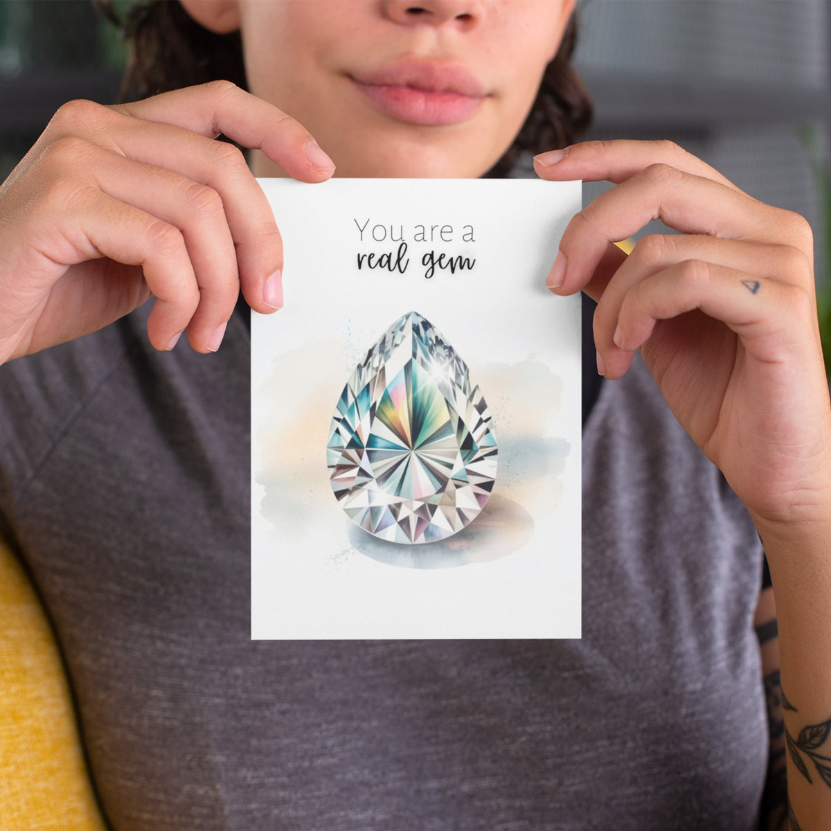 Person holding a card with a teardrop-shaped gem and text 'You are a real gem'.