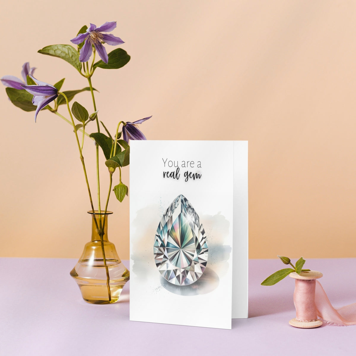 Greeting card with a diamond illustration and flowers on a pastel background