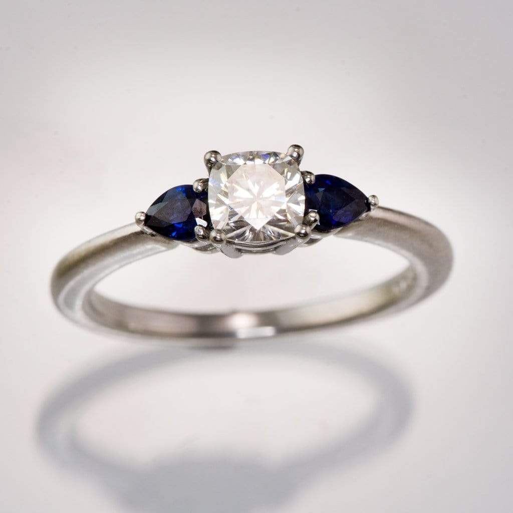 Tressa- Three Stone Engagement Ring, Prong set Cushion Moissanite & Pear Blue Sapphire Accents Ring by Nodeform