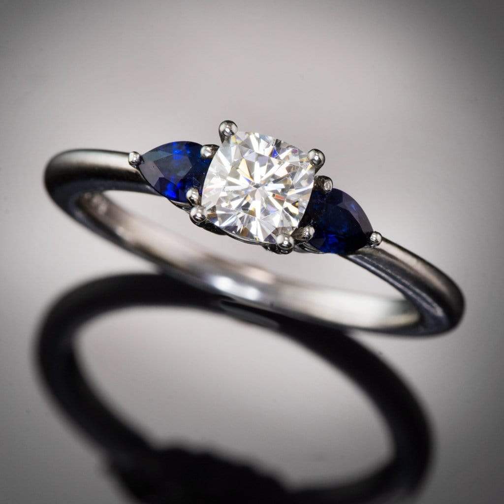 Tressa- Three Stone Engagement Ring, Prong set Cushion Moissanite & Pear Blue Sapphire Accents Ring by Nodeform