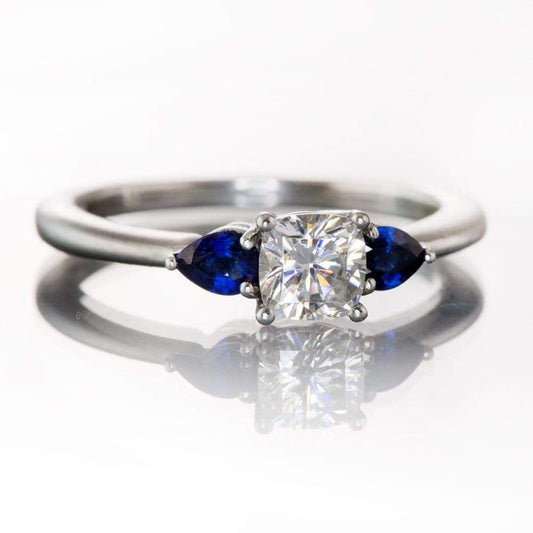 Tressa- Three Stone Engagement Ring, Prong set Cushion Moissanite & Pear Blue Sapphire Accents Ring by Nodeform