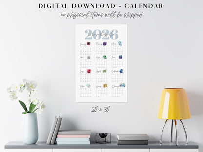 Digital 2026 birthstone calendar displayed on a wall with decor items below.