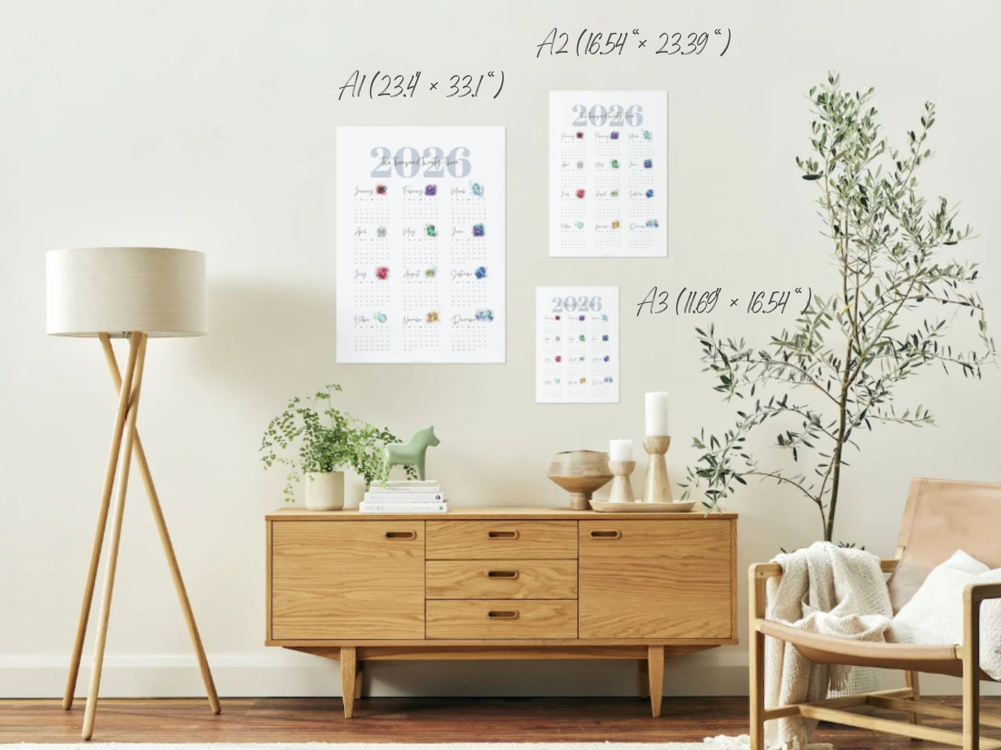 Modern living room with wooden cabinet, lamp, and decorative items and wall hung birthstone calendars in 3 sizes.