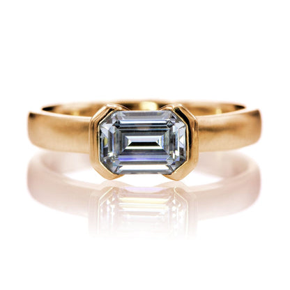 Sideways Emerald Cut Moissanite Ring Half Bezel Halley Solitaire Engagement Ring 7x5mm Forever One / 14k Rose Gold Ring by Nodeform