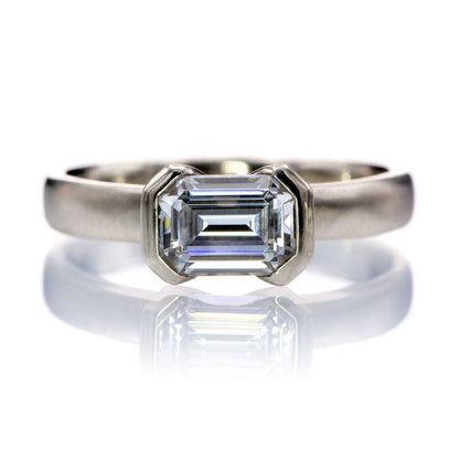 Sideways Emerald Cut Moissanite Ring Half Bezel Halley Solitaire Engagement Ring 7x5mm Forever One / 14k White Gold Ring by Nodeform