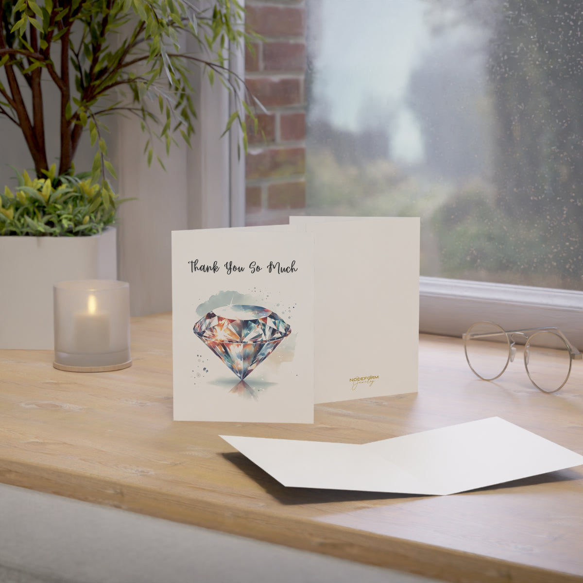 Greeting card with diamond design on a wooden surface near a window