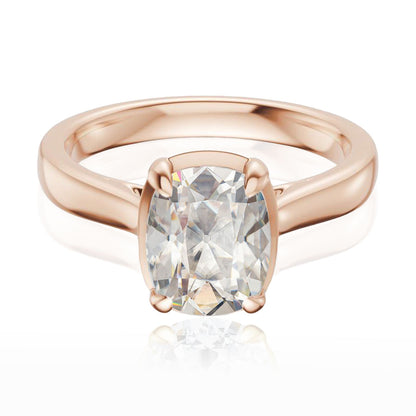 Taylor engagement ring  in rose gold with a large elongated antique cut cushion moissanite on a white reflective background