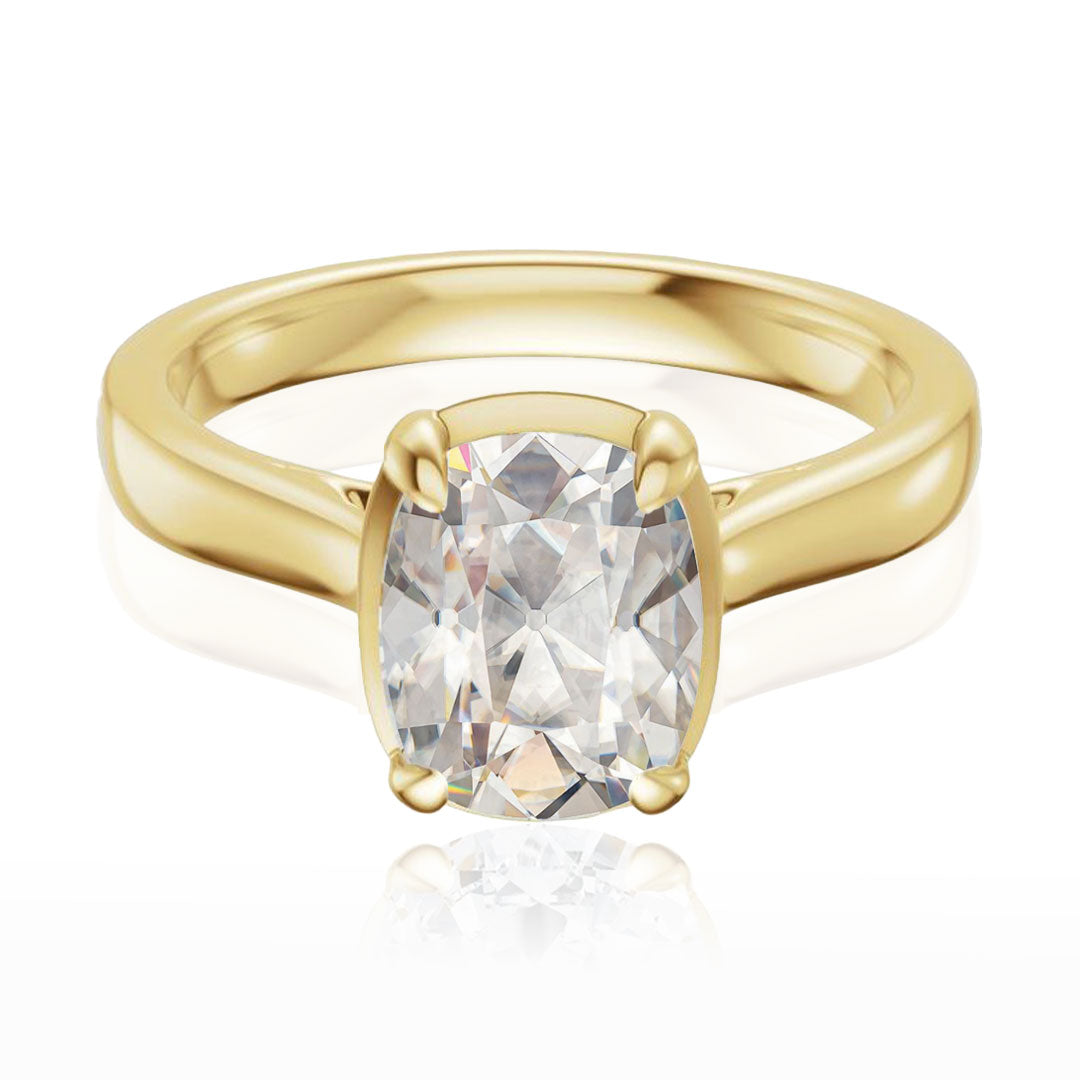 Taylor engagement ring  in yellow gold with a large elongated antique cut cushion moissanite on a white reflective background