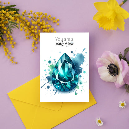 Watercolor Pear Teal Sapphire You are a Real Gem Greeting Card next to flowers
