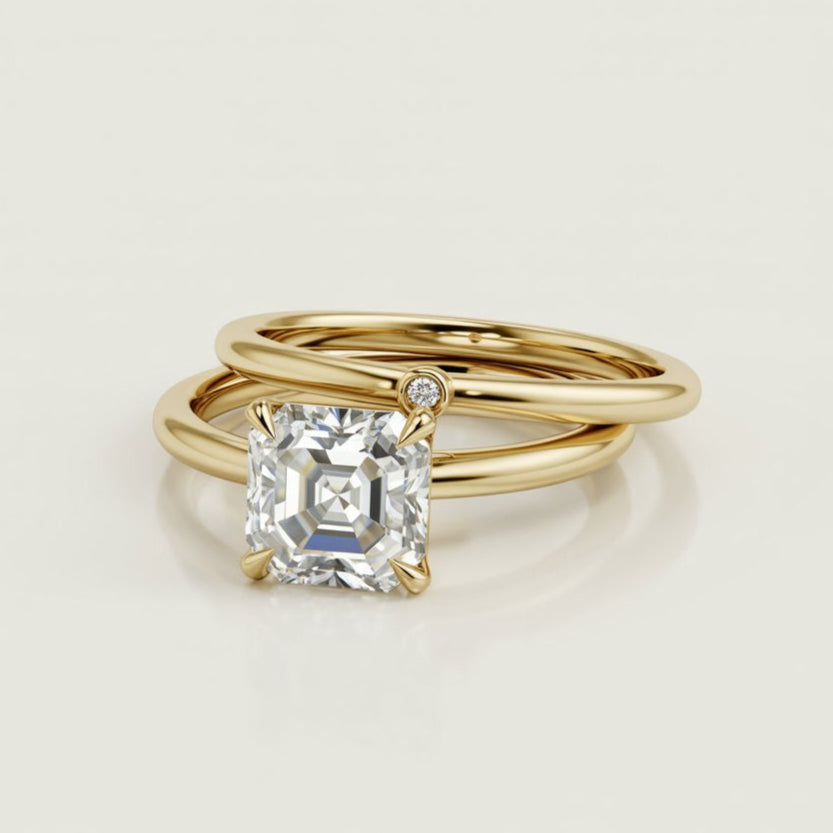 Julia ring with Prong Set asscher cut diamond in a Narrow Cathedral Solitaire Engagement Ring with single diamond gold wedding band
