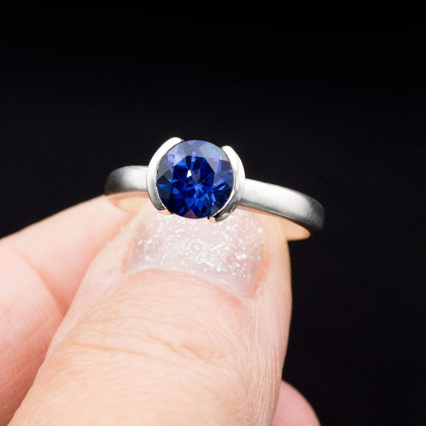 Lab Created Round Blue Sapphire Half Bezel Solitaire Engagement Ring Ring by Nodeform