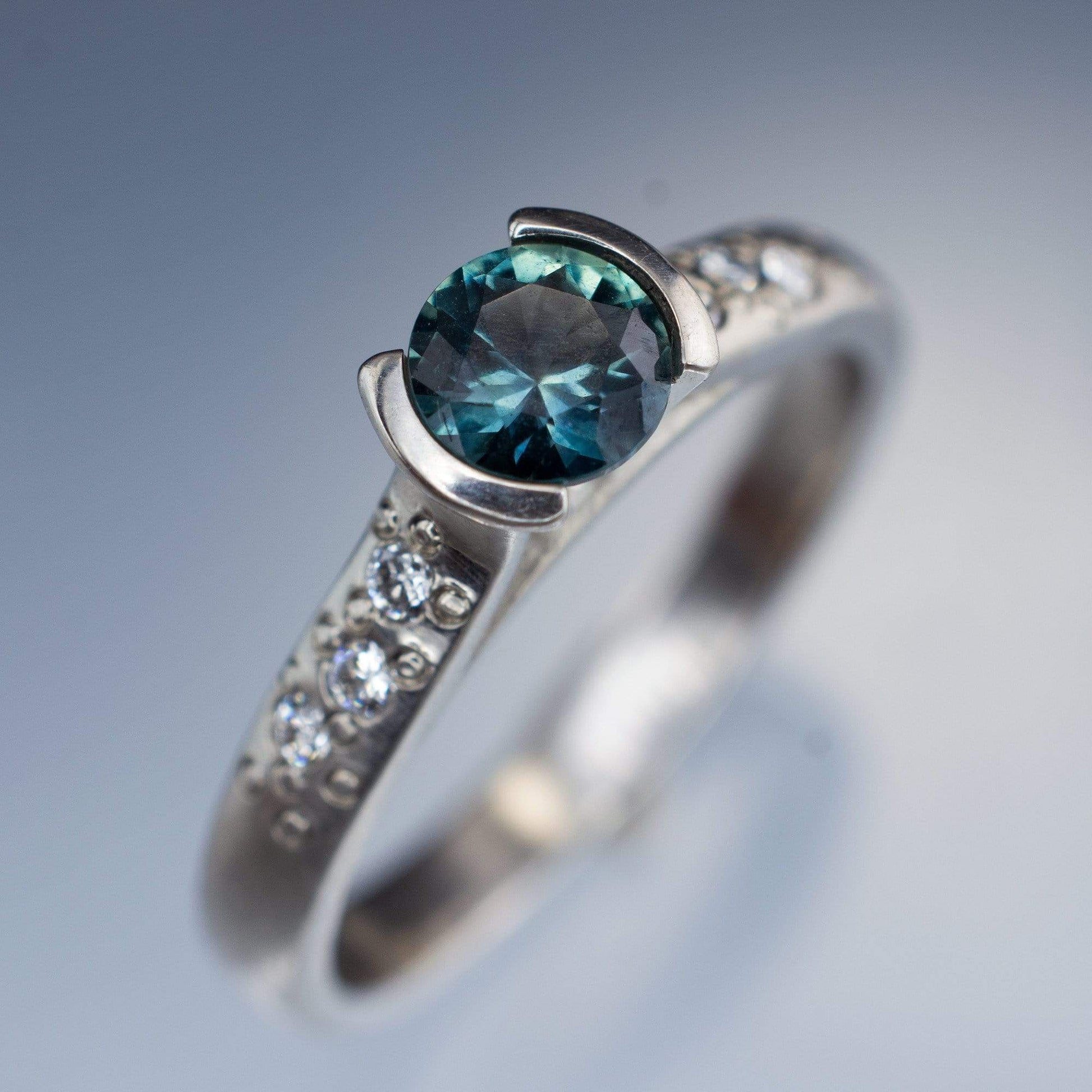 Fair Trade Blue / Teal Montana Sapphire Half Bezel Diamond Star Dust Engagement Ring 5mmTeal Sapphire: C/D / 18kPD White Gold Ring by Nodeform