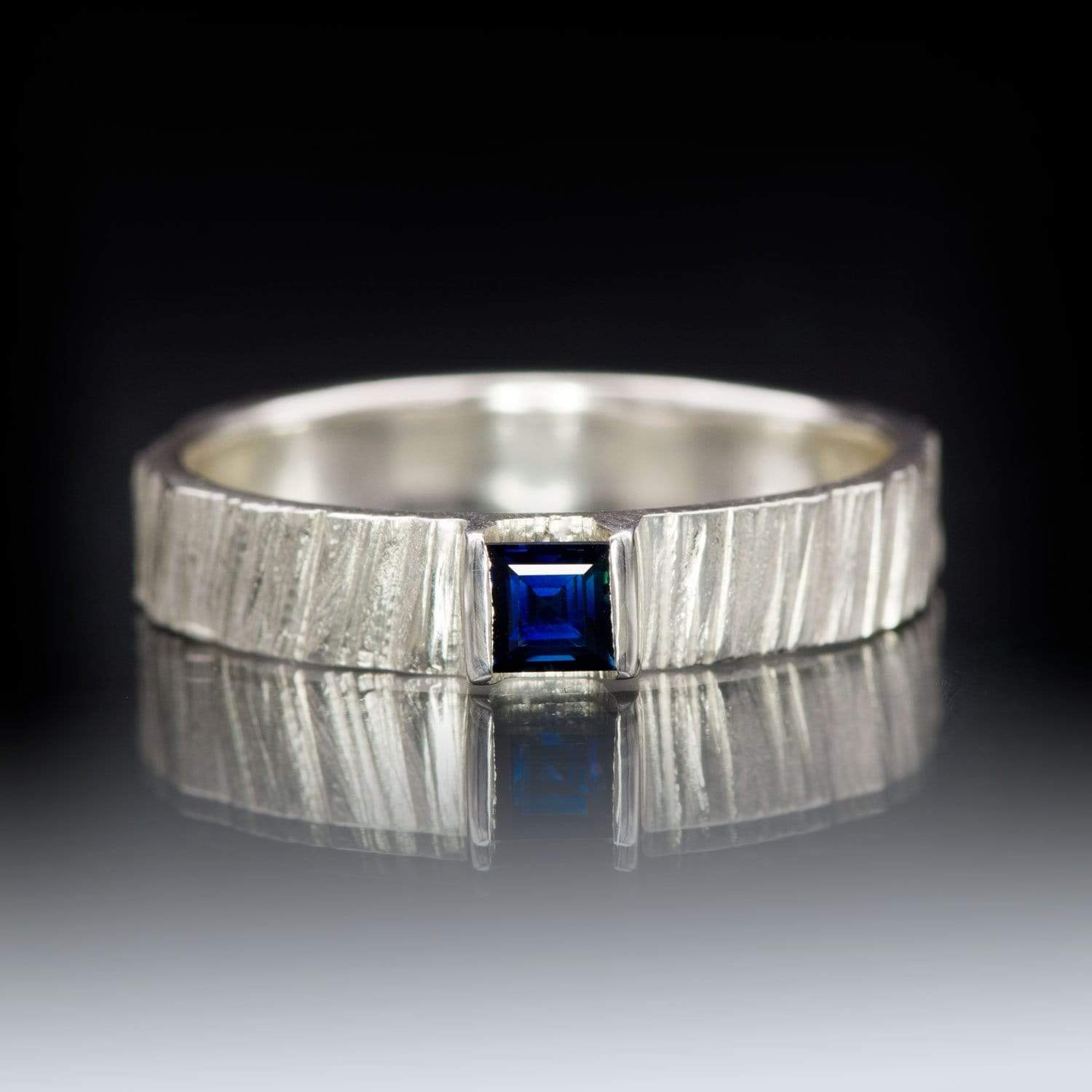 https://nodeform.com/cdn/shop/products/square-3.5mm-blue-sapphire-saw-cut-textured-rustic-wedding-band-silver-DSC_0262.jpg?v=1671516886